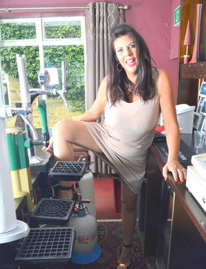 Dark haired girl Petra removes red heels from white pantyhose attired feet